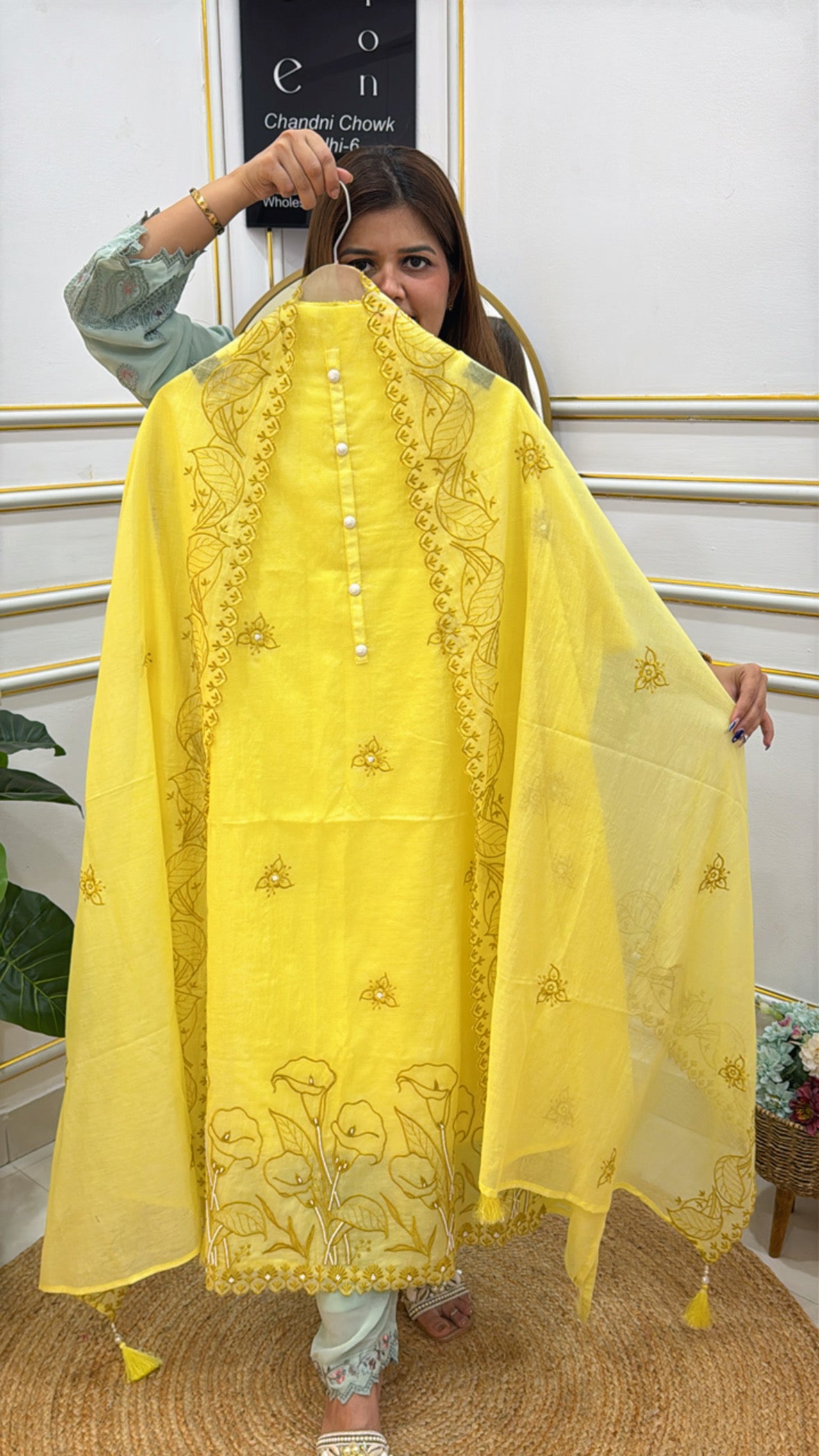 Elegant yellow premium cotton silk unstitched suit featuring intricate embroidery and tassel details